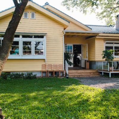 Charming Yellow House With Wooden Windows Green Grassy Garden